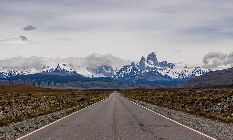 empty road towards mountain, photo of grey road heading toward white and black mountain HD wallpaper