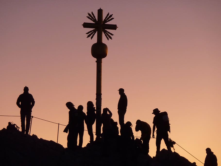 silhouette of brown wooden cross and people, mountaineer, train syringe