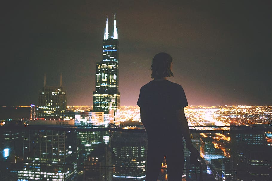 A man enjoying the view across the city at night, people, cityscape