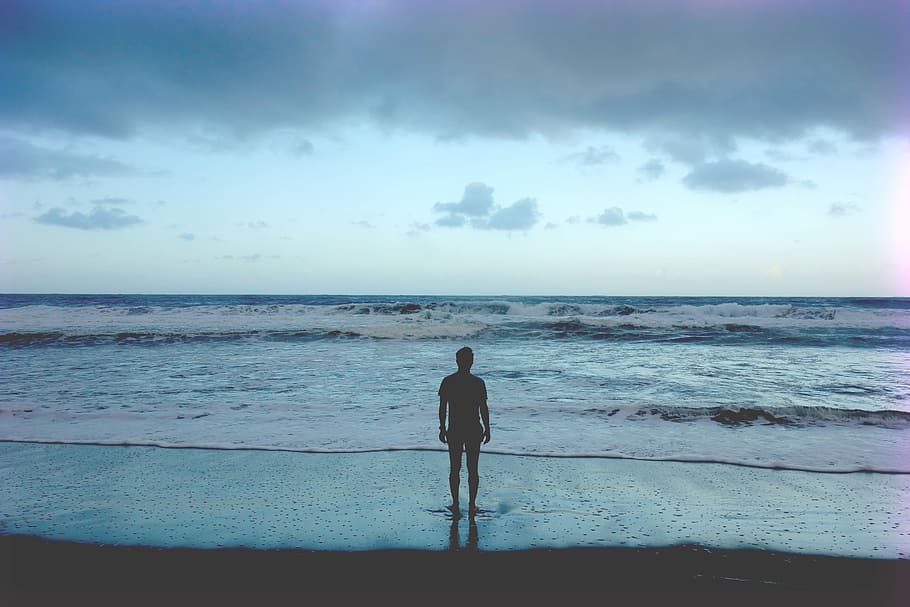 silhouette photography of man standing on seashore, man standing near body of water HD wallpaper