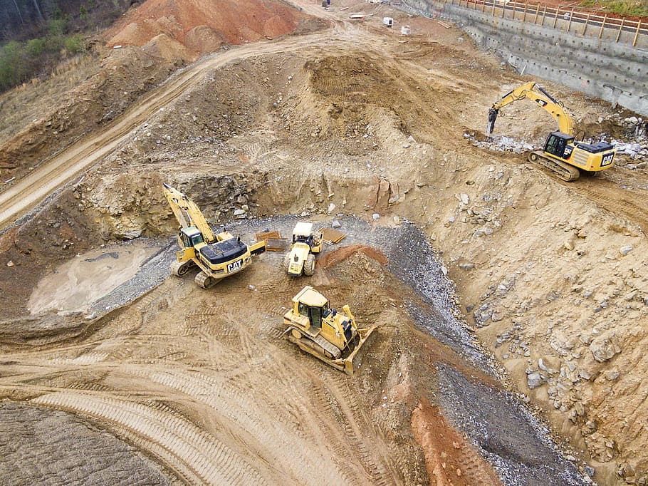 top view photography of four heavy equipment on quarry at daytime, four yellow heavy equipment on sand HD wallpaper