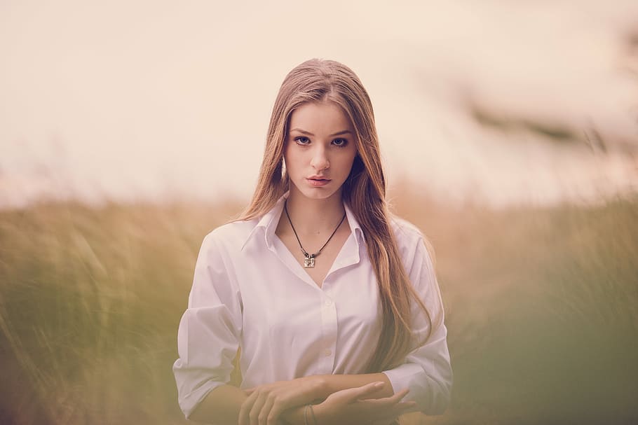 woman in white button-up collared long-sleeved shirt on grass field focus photography, HD wallpaper