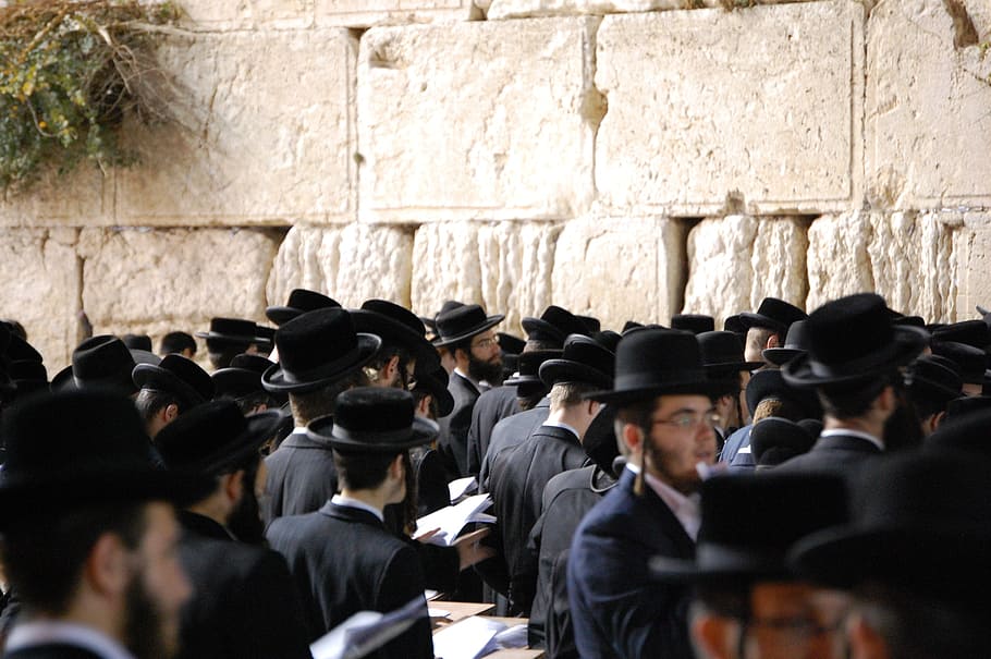 crowd of people wearing black suit and black cap, jerusalem, wall