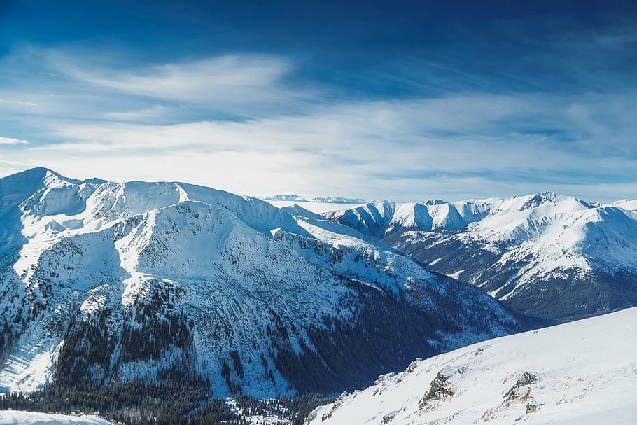 aerial photo of mountain covered by white snow under white clouds during daytime HD wallpaper