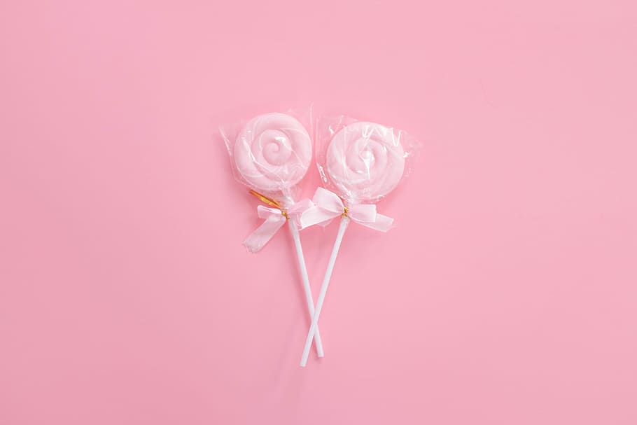 two pink candyes, two pink lollipop packs, flatlay, pastel, minimal
