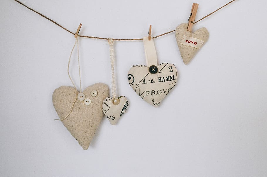 four brown hearts buntingsa, heart-shaped pillows hanging on wall HD wallpaper