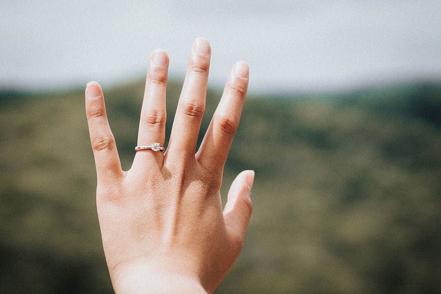 woman showing her silver-colored ring, left human's hands wearing diamond solitaire ring HD wallpaper