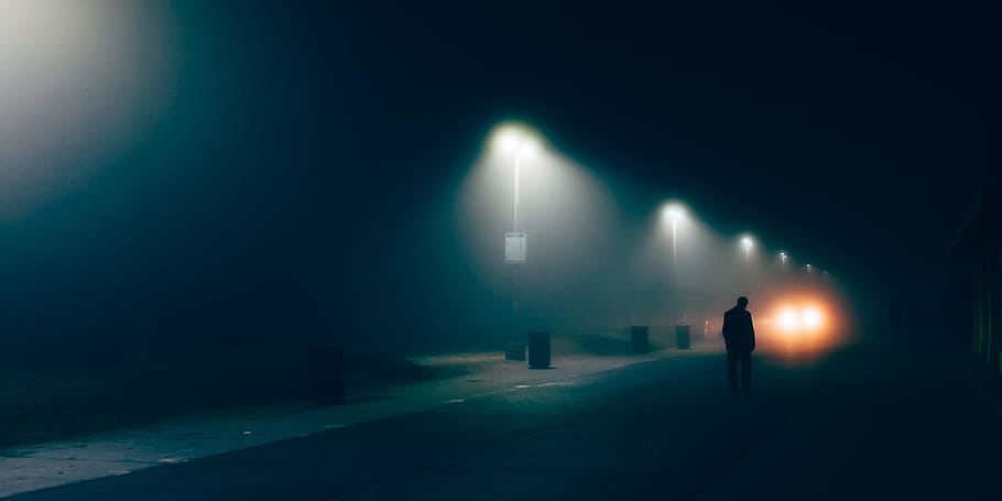 man walking in street photography, dark, people, light, trash