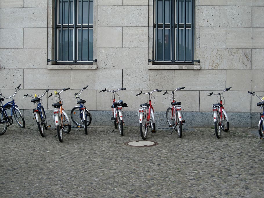 assorted city bicycles near white wall, street, urban Scene, outdoors HD wallpaper