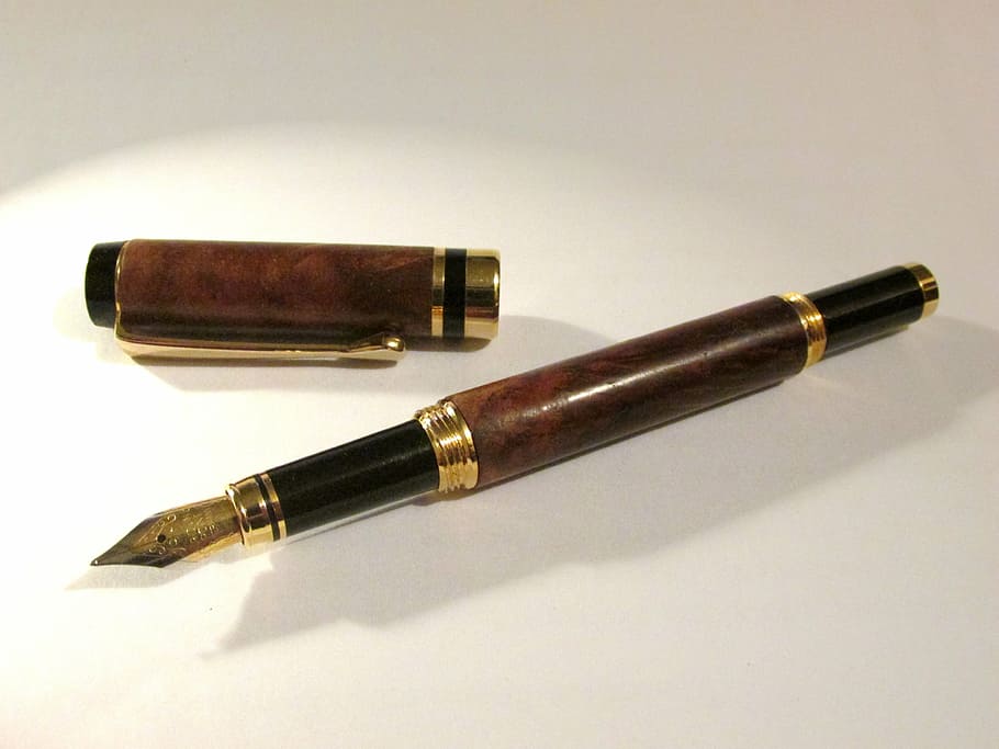 brown fountain pen on white surface, wooden pen, wooden fountain pen
