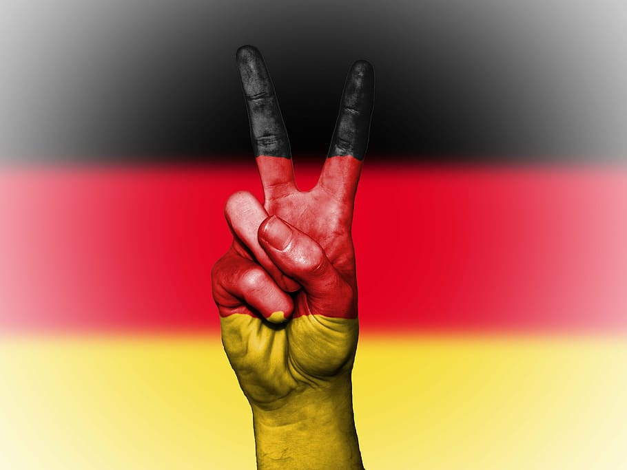 person's hand making peace sign with paint, germany, nation, background