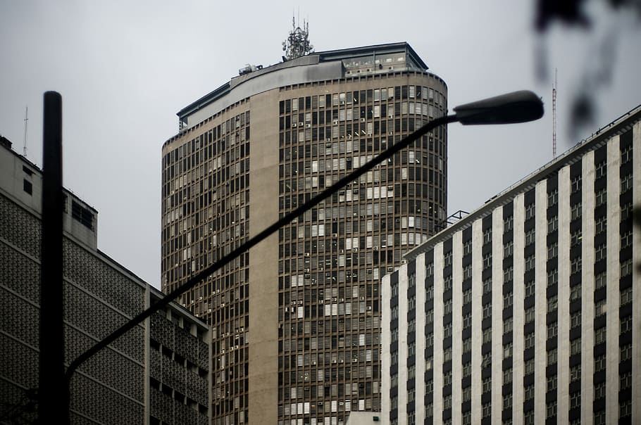 utility post near high rise building, selective focus photography of high rise building HD wallpaper