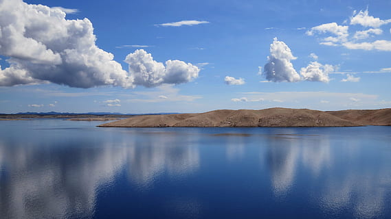 mountain near body of water under white clouds during daytime HD wallpaper