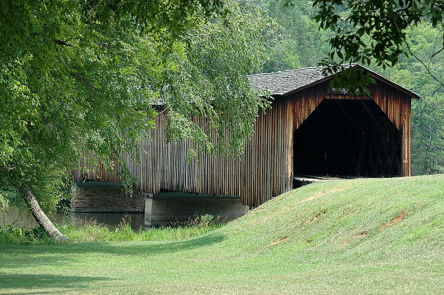 brown wooden tunnel over body of water during day, covered bridge HD wallpaper