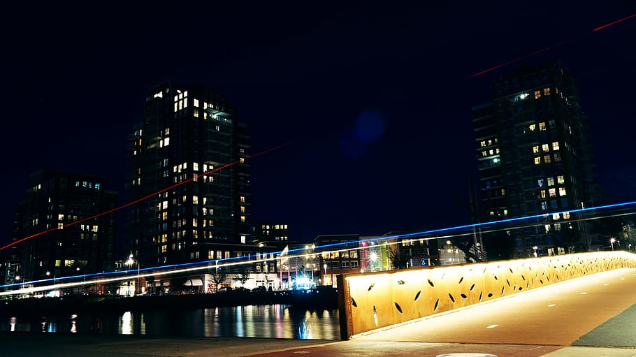 low-angle view of cityscape near body of water, dark, night HD wallpaper
