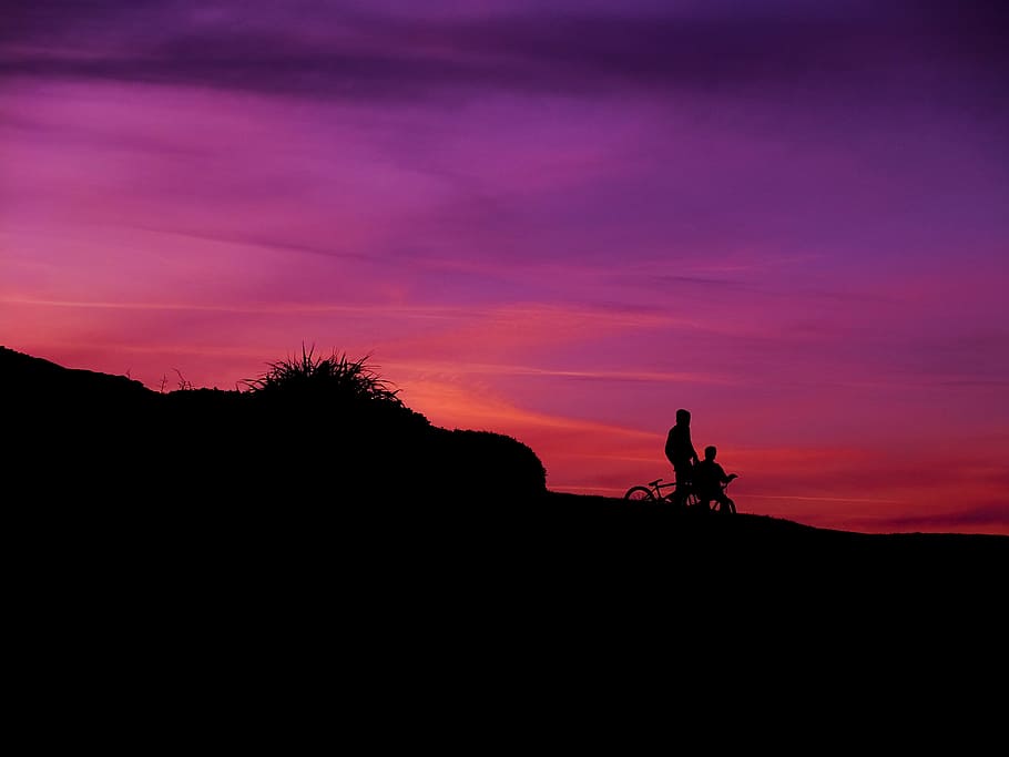 silhouette of two person riding bicycle during sunset, silhouette of two person riding bicycles