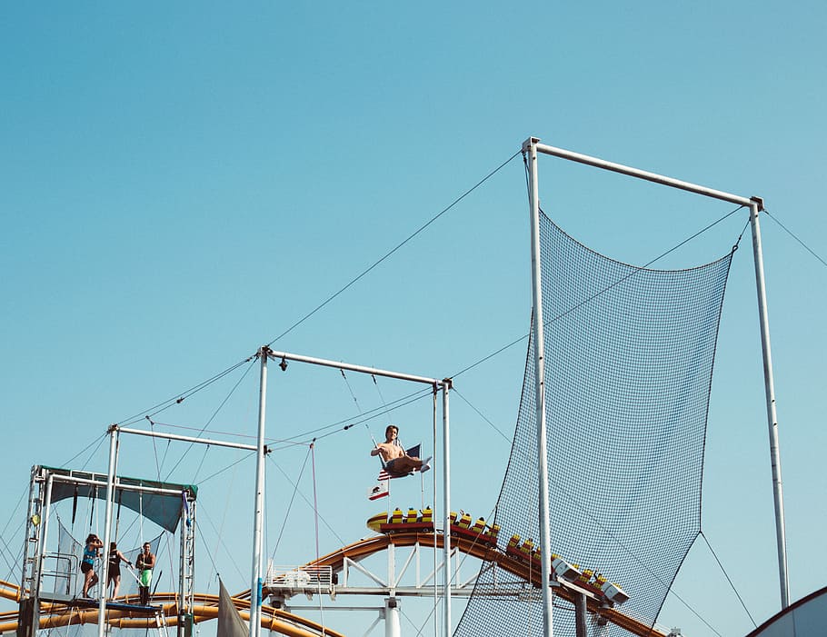 people riding swings outdoor, trapeze, pier, roller coaster HD wallpaper