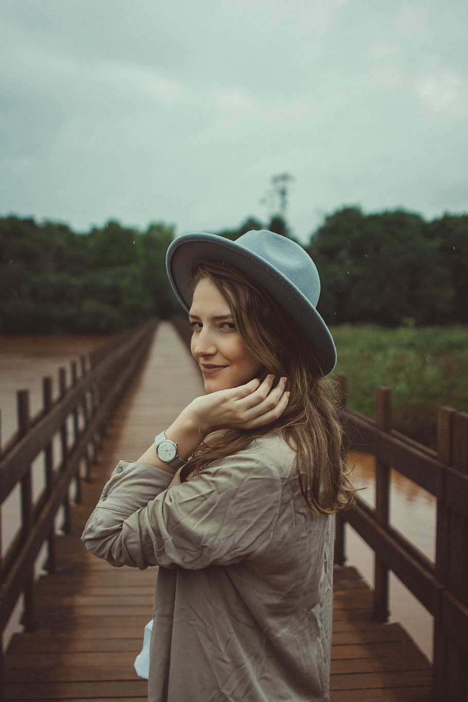 woman holding her brown hair, person, looking back, hat, watch HD wallpaper