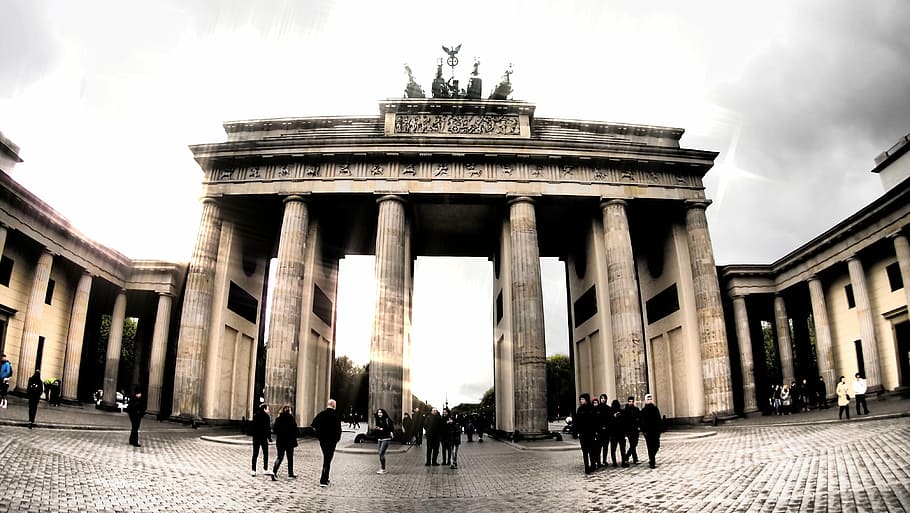 group of people standing near arch, berlin, brandenburg gate