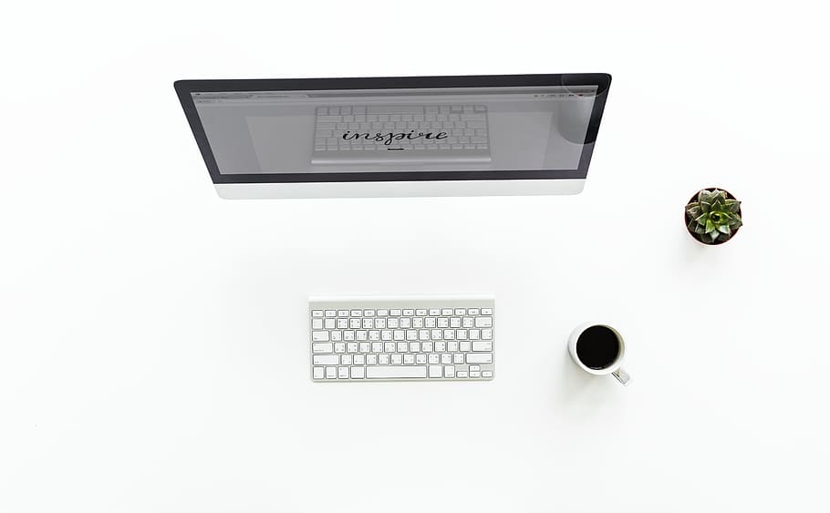 high angle view of turned on computer monitor beside wireless keyboard HD wallpaper