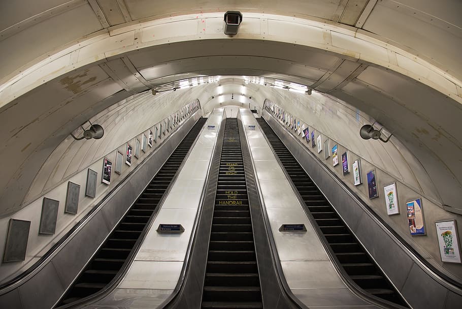 worm's eye view of escalator, selective photo of gray and black tunnel scallator HD wallpaper