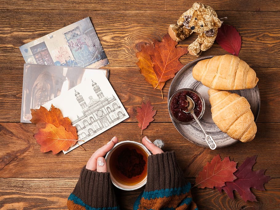 flat lay photography of person holding teacup with two croissant bread on gray tray, flat lay photography of three pictures, leaf, and bread on table HD wallpaper