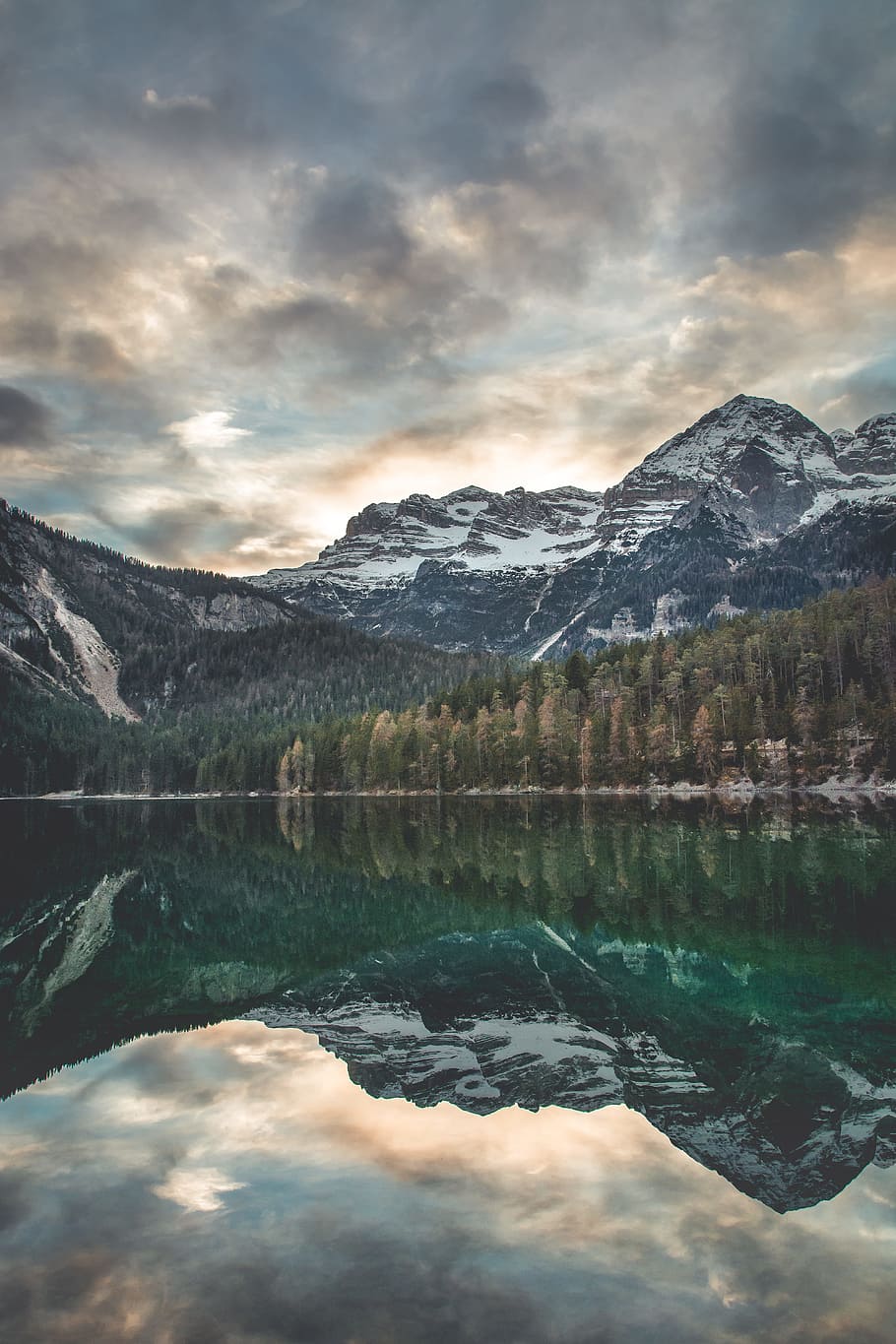 scenery of trees and mountain, landscape photography of body of water across pine trees and mountain at daytime