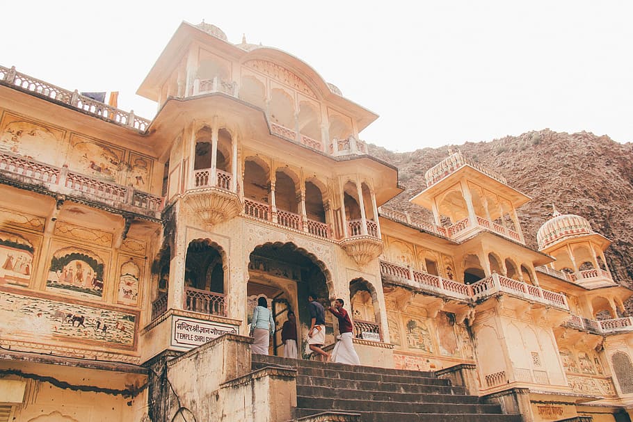 people entering the entrance of beige temple at daytime, four person stepping on beige concrete door building at daytime HD wallpaper