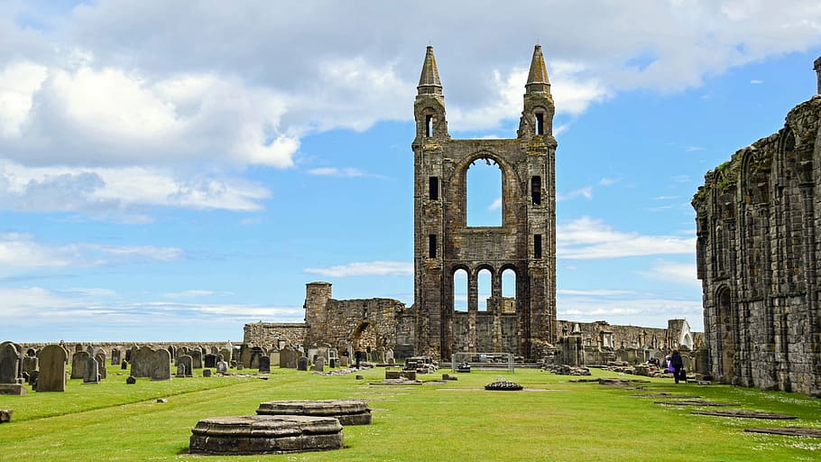photo of beige castle ruins with green grass, scotland, st andrews