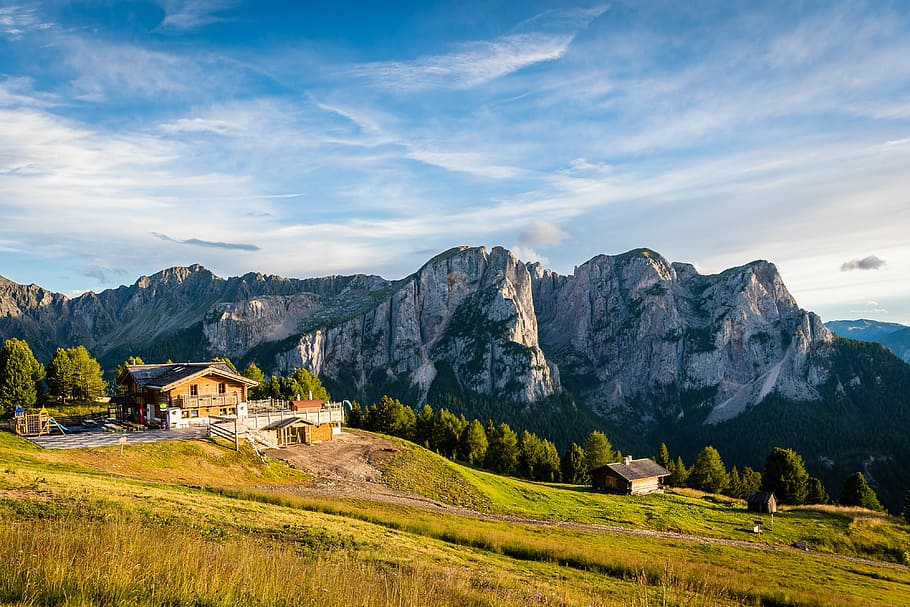 brown and white concrete house near mountain peak, photography of mountain HD wallpaper