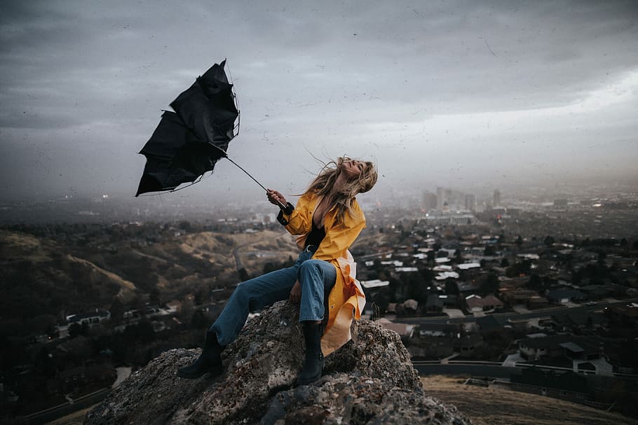 woman sitting on rock with her umbrella being blown away, wind, HD wallpaper