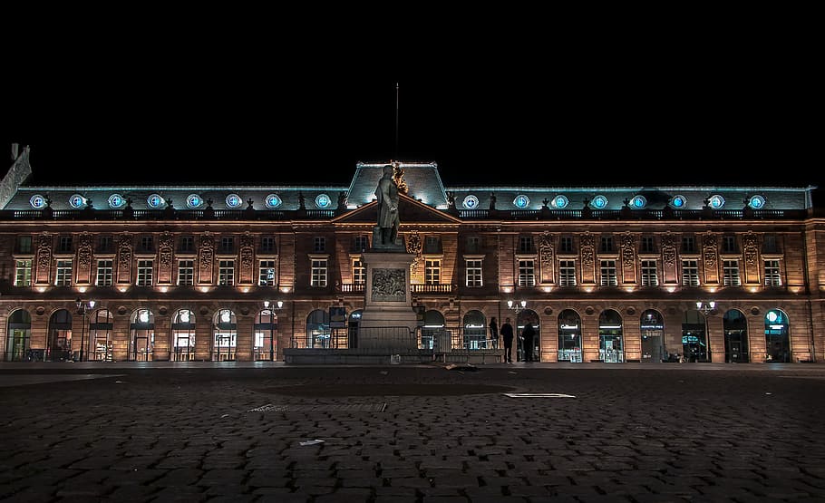 landscape photo of building during nighttime, brown building with lights during nighttime HD wallpaper