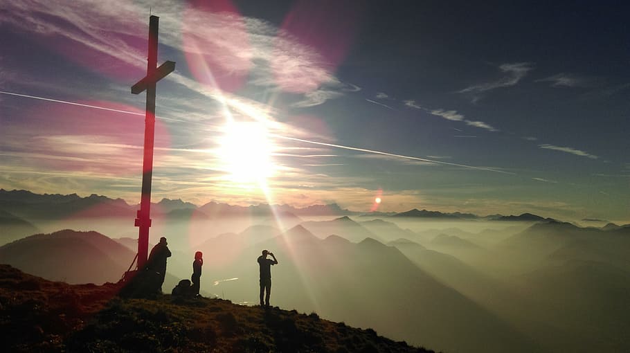 silhouette photo of three person standing beside cross during sunrise HD wallpaper