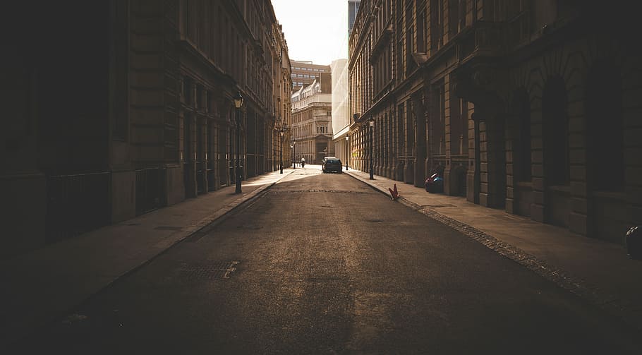 sepia photography of street in the middle of high-raise two buildings HD wallpaper