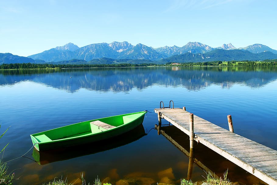 green boat docking on brown wooden body of water dock, bavaria