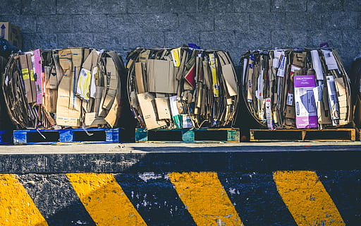 assorted box lot on brown wooden pallets, assorted-color cardboard box leaning on concrete wall HD wallpaper