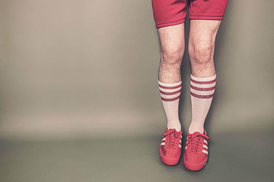 portrait of a person's legs wearing a pair of red adidas sneakers and pair of white-and-red high socks, HD wallpaper