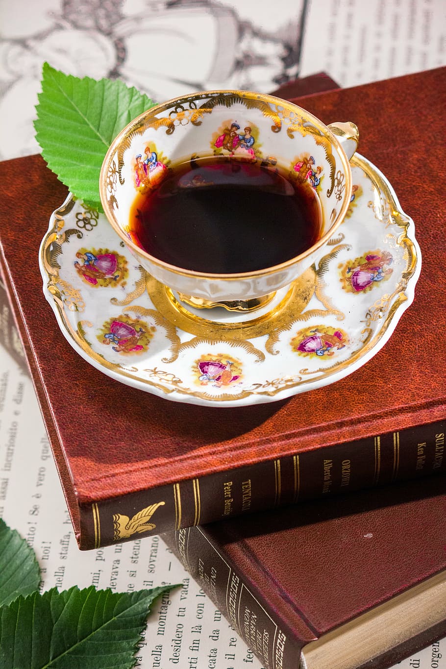 white and multicolored-print teacup with saucer, reading, porcelain HD wallpaper