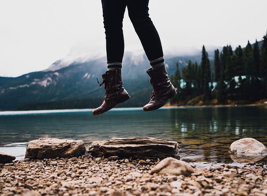 person jumped near lake shore during daytime, person jumping near body of water HD wallpaper