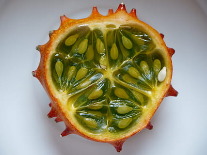 sliced round spike fruit, kiwano, split, half, cores, seeds HD wallpaper