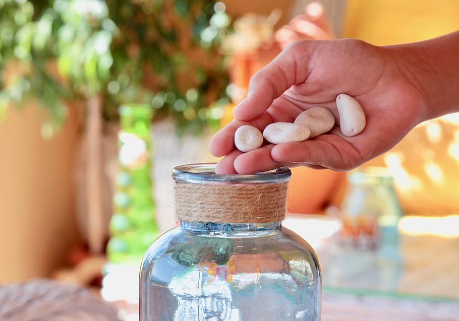 four white stones and clear glass jar, hand, sassi, glass jars HD wallpaper