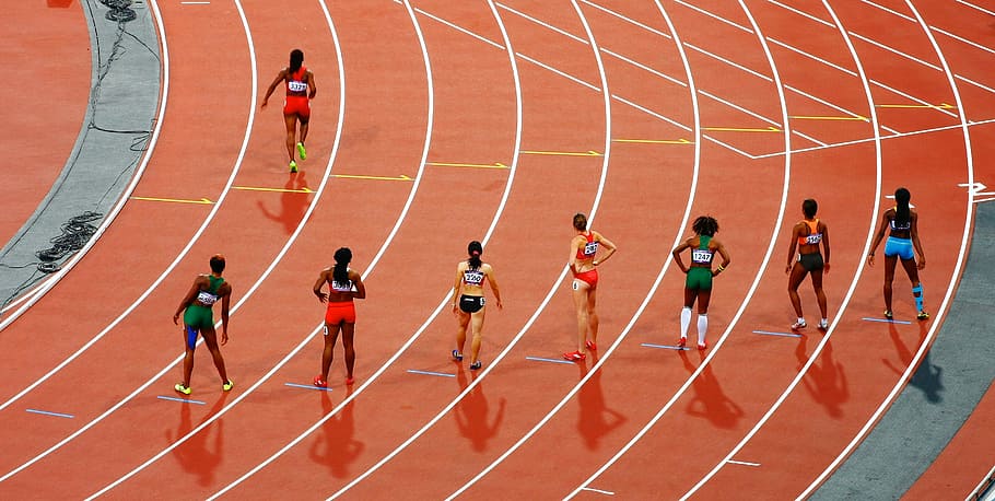 women running on race track during daytime, track and field runners