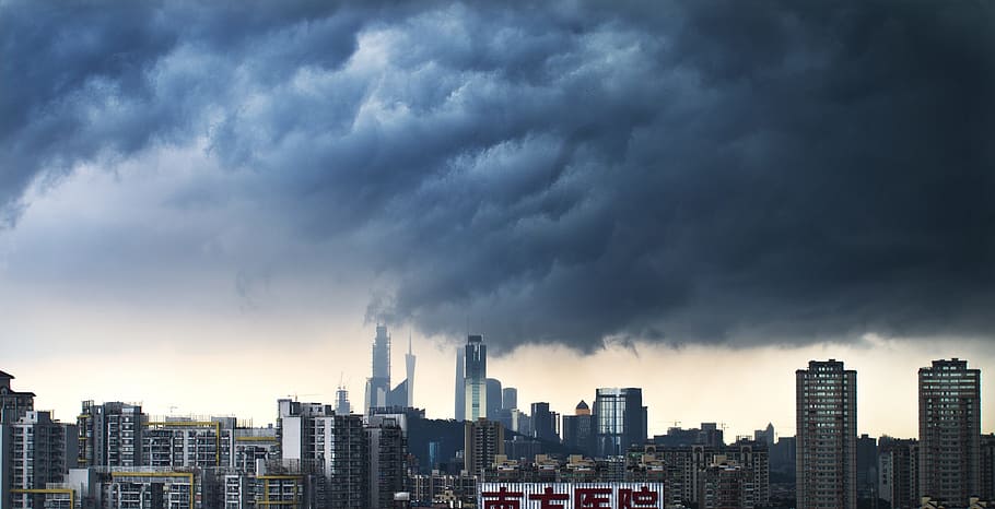city skyline under blue and black clouds, canton, rainstorm, the scenery