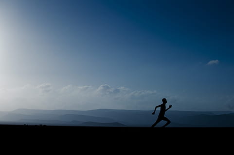silhouette of man sprinting under blue clouds, landscape, mountains HD wallpaper