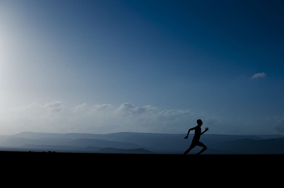 silhouette of man sprinting under blue clouds, landscape, mountains HD wallpaper