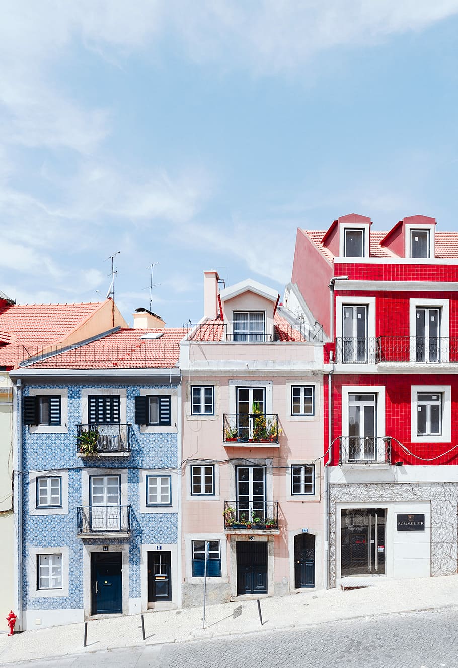 white and red concrete house, three blue, pink, and red concrete houses HD wallpaper