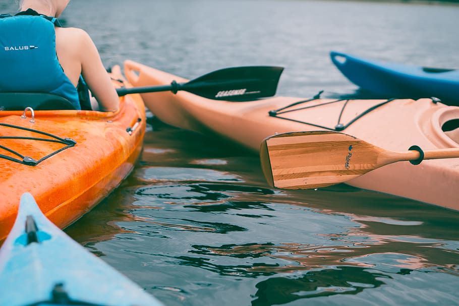 person riding on orange kayak during daytime, person wearing black vest riding on kayak with paddle HD wallpaper