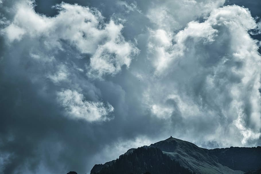 mountain range under cloudy sky, snow covered mountain under gray sky during daytime HD wallpaper