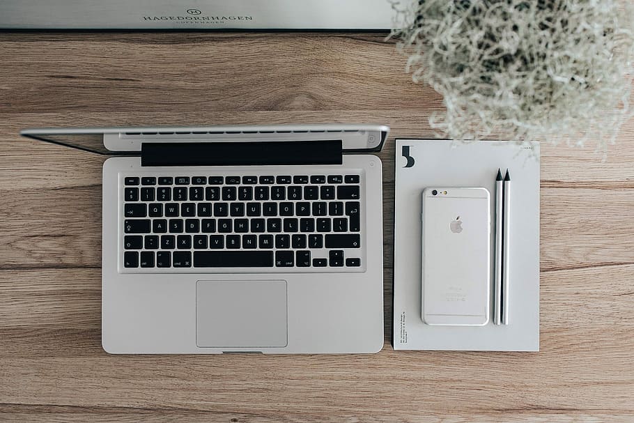 Silver Acer laptop on a wooden desk with a green plant, pencils and an Apple iPhone, HD wallpaper