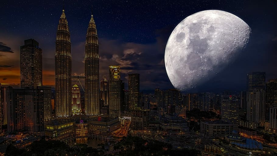 aerial photography of city buildings with moon overlay digital art